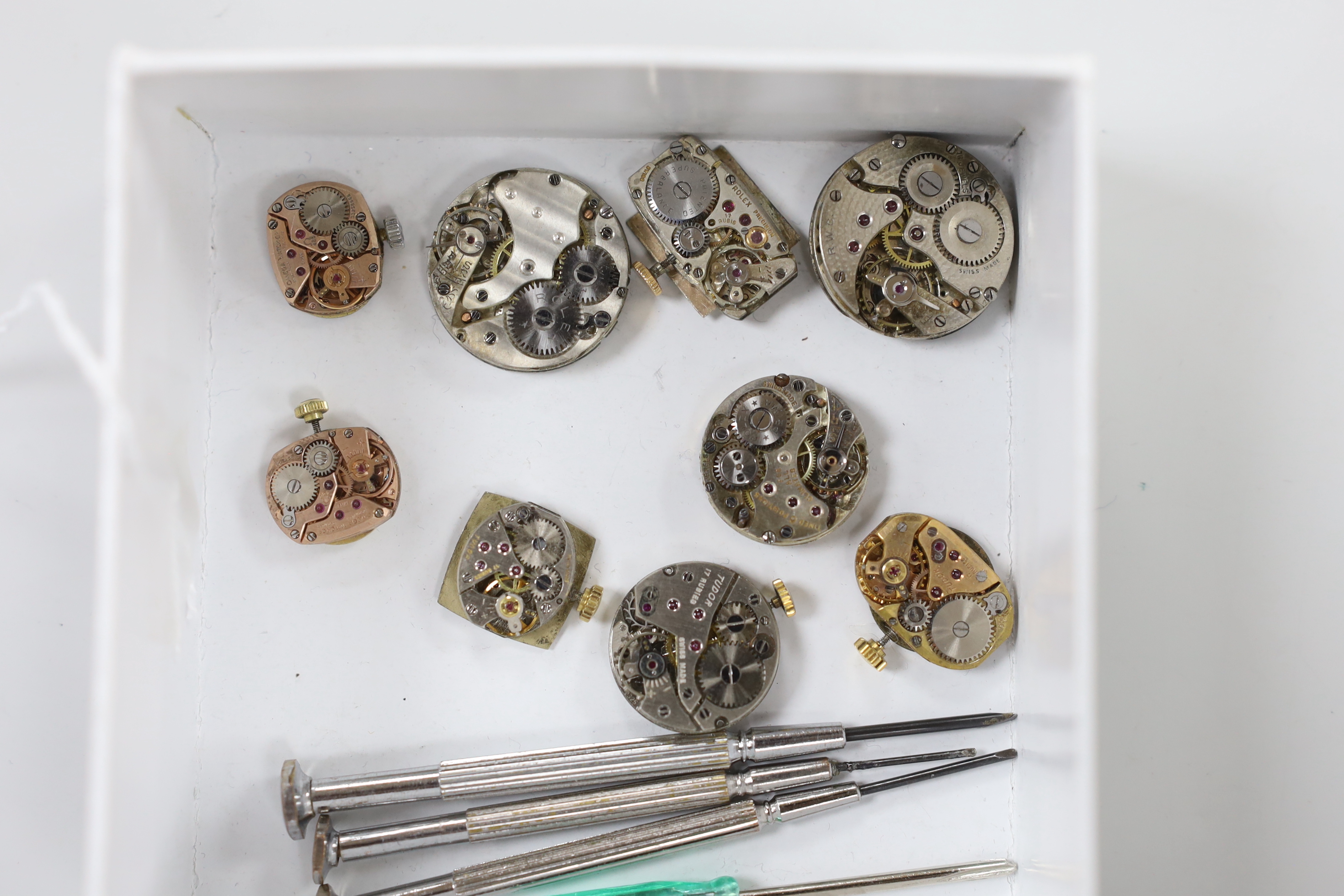 Nine assorted mainly lady's watch movements, including Rolex, Tudor and Omega and four watch tools.
